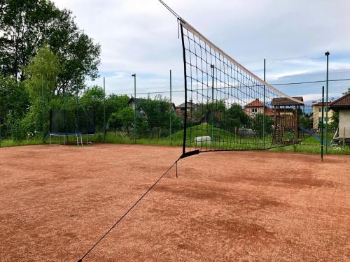 a tennis court with two nets on top of it at Guest House Maxim in Liptovský Mikuláš