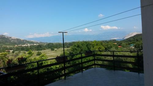 a balcony with a view of the mountains at Podmartine in Baška