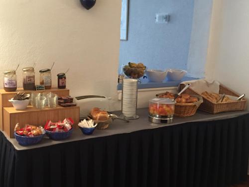 a table with bread and baskets of food on it at Hotel Bellevue in Saint-Florent