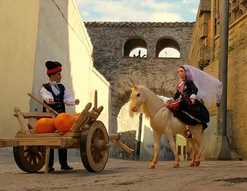 a man riding a horse pulling a cart with oranges at B&B Sa Pintadera in Muravera