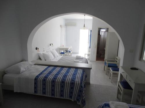 a bedroom with a large bed and an archway at Castelopetra in Katapola