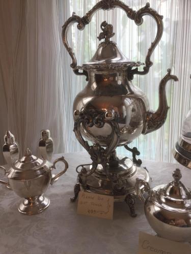 a large silver vase sitting on top of a table at Aaron House of Niagara Falls in Niagara Falls