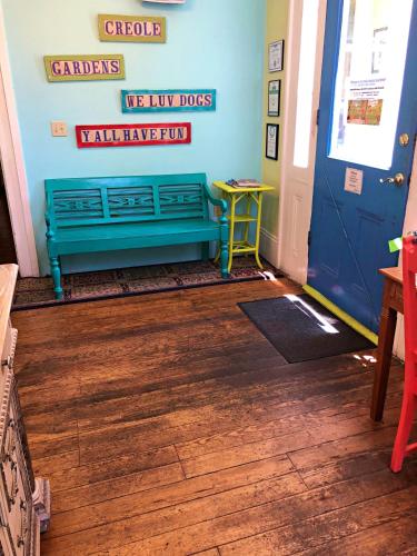 a hallway with a blue bench in a room at Creole Gardens Guesthouse and Inn in New Orleans