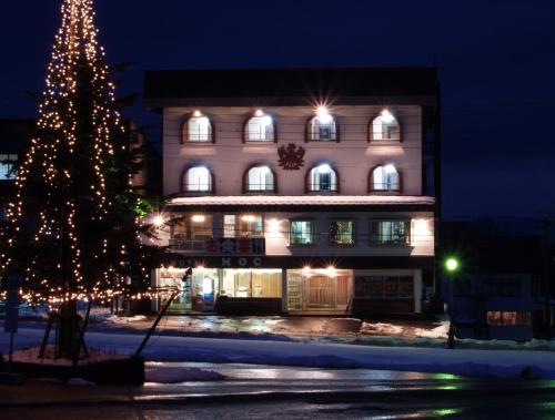 a christmas tree in front of a building at Hotel Moc in Myoko