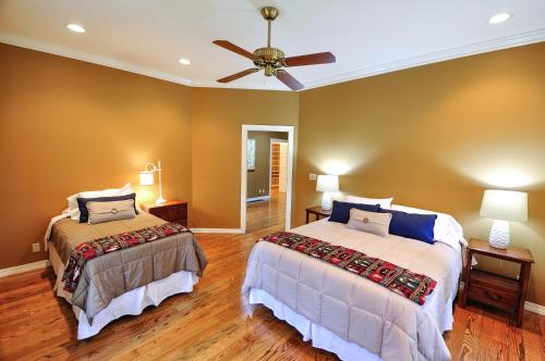 a bedroom with two beds and a ceiling fan at Glacier Homestead in Coram