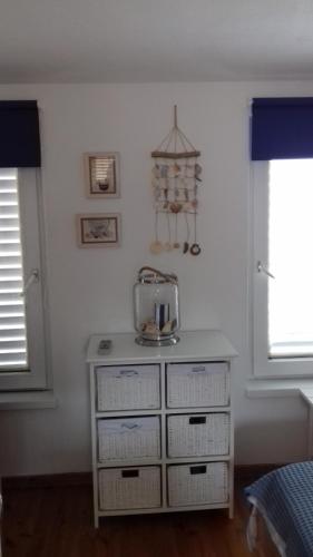 a white dresser with a blender on top of it at Studio with magic view in Podgora
