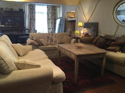 a living room with a couch and a table at Le Logis Alexandra BnB in La Trimouille