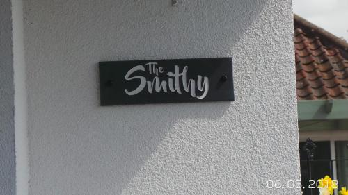 a sign that says the smithy on a wall at The Smithy in Largoward