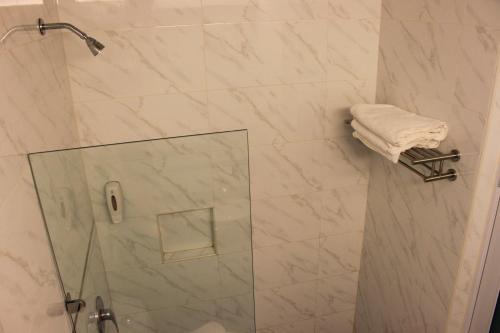 a bathroom with a shower with a glass door at Hotel Time Boutique Nilai in Nilai