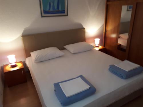 Un dormitorio con una cama con una tablet. en Apartments Aria en Stari Grad