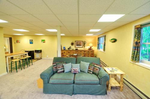 a living room with a blue couch and a table at Glacier Homestead in Coram