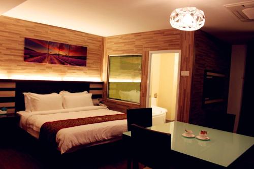Postel nebo postele na pokoji v ubytování Hotel Time Boutique Nilai