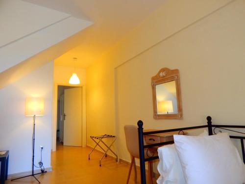 a bedroom with a bed and a mirror on the wall at Kripis Studio Paliouri in Paliouri