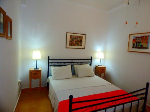 a bedroom with a bed with two lamps on two tables at Kripis Studio Paliouri in Paliouri