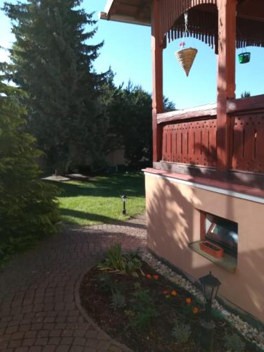 a porch of a house with a brick walkway at Penzión Rodina in Levoča