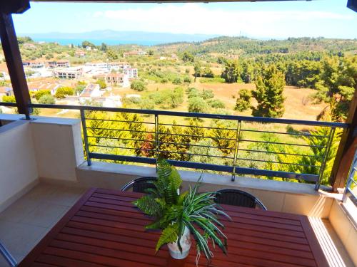a balcony with a table and a view of the mountains at Kripis Studio Paliouri in Paliouri