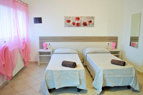 Katil atau katil-katil dalam bilik di Sardegna Mer et Soleil in Olbia