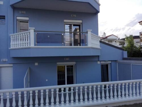 a blue house with a white balcony at Milla Lux 2 in Paralia Katerinis