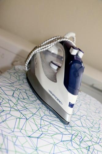 a iron sitting on top of a table at Porto Patricio Apartments in Porto