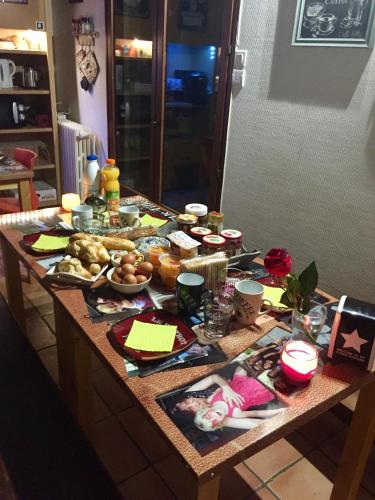 a table with food on it in a kitchen at Au Nid de Tillé in Tillé