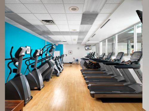 a gym with rows of treadmills and ellipticals at Hotel Grand Pacific in Victoria