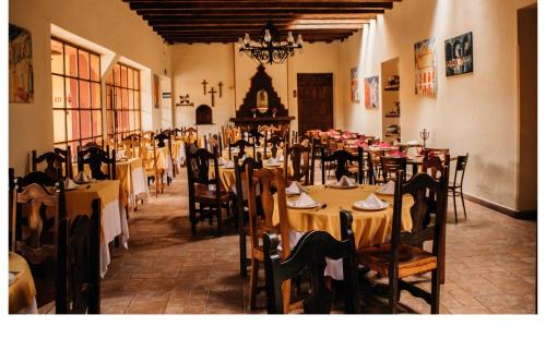 a dining room with tables and chairs in a building at Hotel Diego de Mazariegos in San Cristóbal de Las Casas