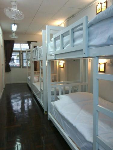 a room with three bunk beds in a room at Nine Place Sukhumvit 40 in Bangkok