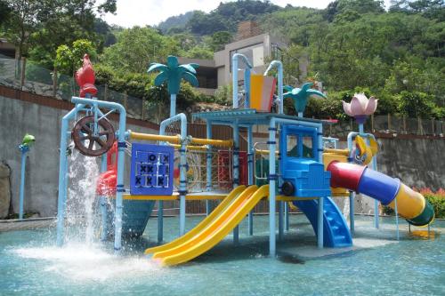 a water park with a slide in the water at Go Ya Hot Spring in Heping