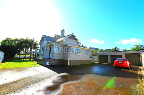 a house with a car parked in a parking lot at Regent Residential Villa in Whangarei