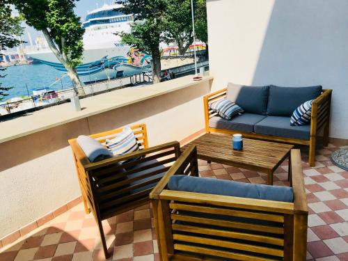 a patio with two chairs and a couch and a table at Apartments & rooms Artemus Belveder in Koper
