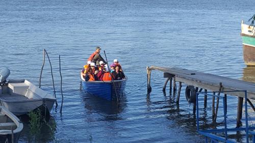 a group of people in a boat on the water at Pensiunea Delta D.M.Y. in Mahmudia