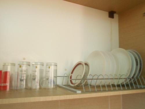a shelf with some dishes and cups on it at Villa Sofia in Ialysos