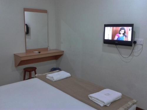 Un pat sau paturi într-o cameră la Hotel Sri Malim Sungkai