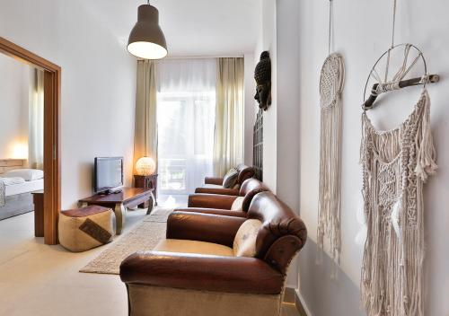 a living room with a leather couch and a tv at Ośrodek wypoczynkowy Balt-Tur Feel Well Resort in Jastrzębia Góra