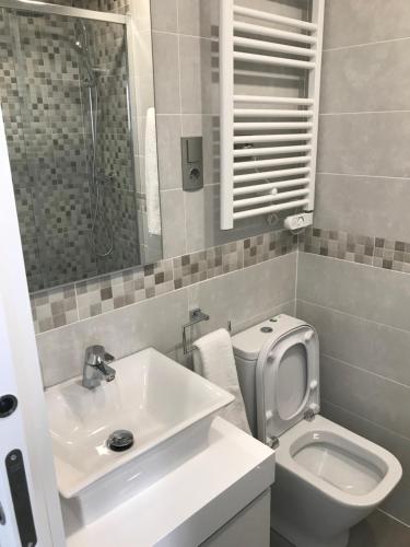 a white bathroom with a sink and a toilet at Nicoletta in Madrid
