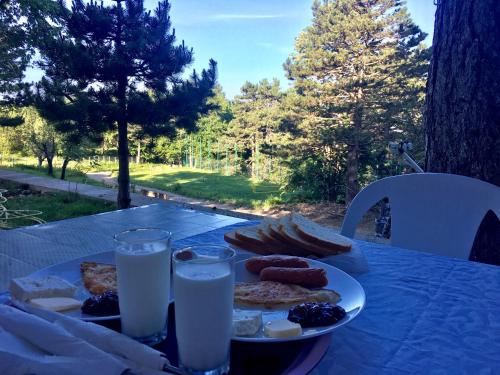 a plate of food on a table with milk at Shkreli Resort Qafeshtame in Krujë