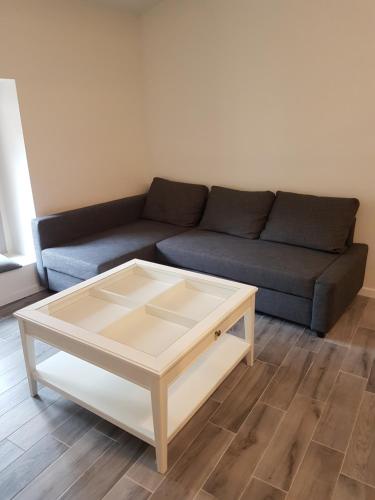 a living room with a couch and a coffee table at Edelweiss in Saint-Guilhem-le-Désert