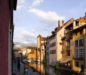 a view of a canal in a city with buildings at "Un Lieu Unique" Le Lodge et le Dolce in Annecy