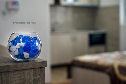 a bowl filled with blue crystals sitting on a table at Mrzenci Apartments in Gevgelija