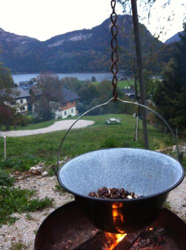 a pot over a fire on a grill at Reitbauernhof Schartner in Altaussee