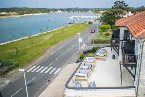 a balcony of a building with a street and a road at Single Fin Hotel & Lodge in Mimizan-Plage