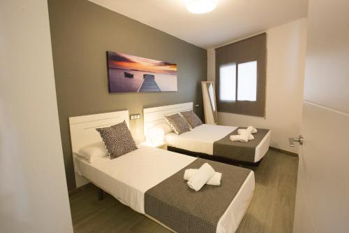 Кровать или кровати в номере Apartamentos Fabiola