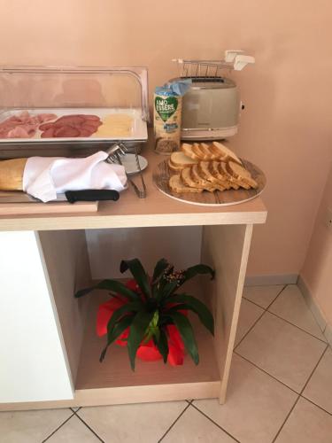 a table with a plate of food and a toaster at Villa Saturno in Tropea