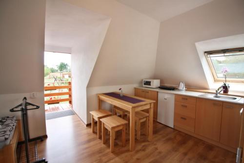 a small kitchen with a table and a sink at U Slunce in Čížov
