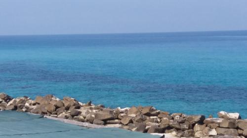 a group of rocks on the shore of the ocean at Villaggio Camping Fiorina in Capo Vaticano