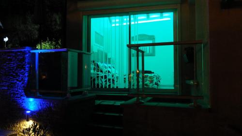 a room with a window with a blue light at La Cadanise, Suite Étoilée in Saint-Éloy-les-Mines