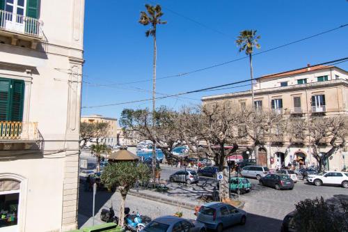 a city street with palm trees and a parking lot at Apollo B&B in Siracusa