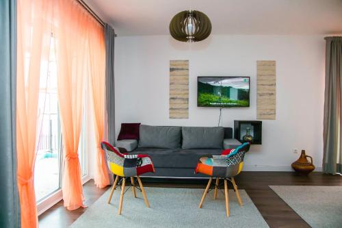 a living room with a couch and two chairs at LGP Exclusive Apartment in Bihać