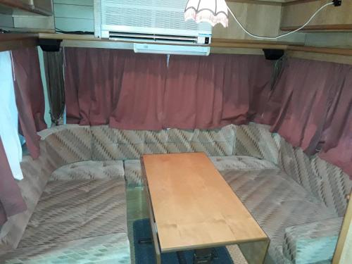 a couch with a table in a room with a window at For Nature Lovers in Skala Rachoniou