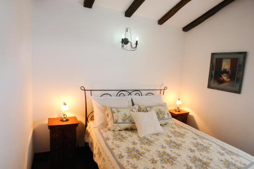 a bedroom with a bed with two night stands and two lamps at Robinson Villa Afrodita in Nerežišća